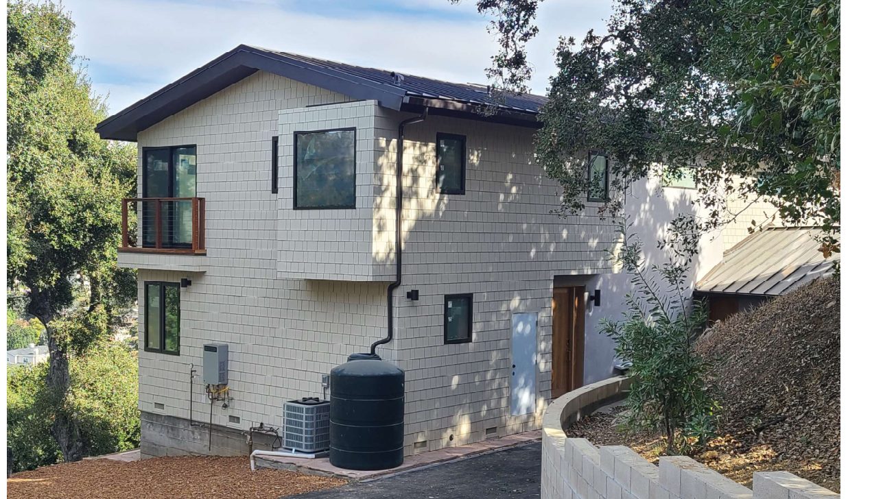 Reclad two-story home with added floor after renovation