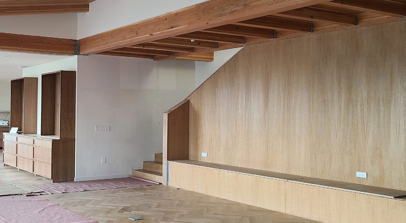 Great room with built-in millwork and herringbone floor